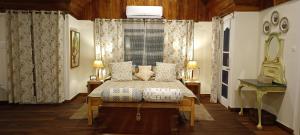 a bedroom with a bed and a window at Chinarchalet in Pālampur