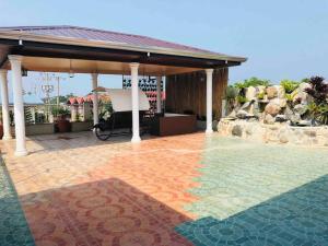 a patio with a pavilion and a mosaic floor at Luzville Residences - C8 in Naic