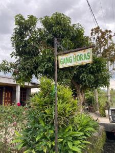 a street sign for a gang horoscopes at Paima Homestay in Laguboti