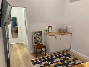 a kitchen with a counter and a chair in a room at Blue Heart Studio Apartment in Willunga