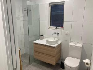 a bathroom with a sink and a toilet and a shower at Blue Heart Studio Apartment in Willunga