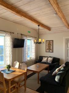 a living room with a couch and a table at Proselinsgården in Bjursås