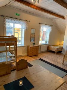 a room with a bunk bed and a table at Proselinsgården in Bjursås