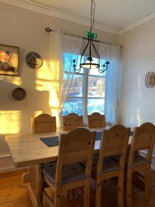a dining room with a table and chairs and a window at Proselinsgården in Bjursås