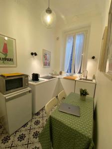- une cuisine avec une table et un ordinateur portable dans l'établissement La Chic Maison de Milan, à Milan