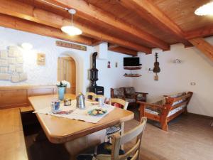 a dining room with a wooden table and chairs at Delightful hut with spectacular views of the Pale di San Martino in Tonadico