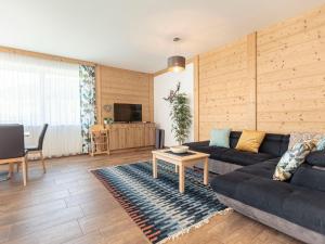 a living room with a couch and a table at Beautiful chalet in St Lambrecht with infrared sauna in Sankt Lambrecht