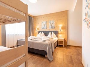 a bedroom with a large bed and a wooden wall at Beautiful chalet in St Lambrecht with infrared sauna in Sankt Lambrecht