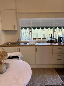 a kitchen with a sink and a counter top at ENCHANTING SELF-CATERING VILLA with QUEEN BED AT BOKMAKIERIE VILLAS in Windhoek