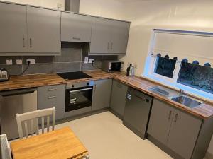 a kitchen with stainless steel appliances and a wooden table at Glencree Air in Waterford