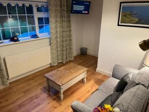 a living room with a couch and a coffee table at Glencree Air in Kilmeaden