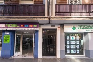 a group of buildings with doors open on a street at Apartamento cerca del mar, del puerto y del centro in Valencia