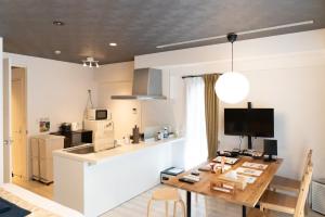 a kitchen and dining room with a table and a counter at Fuchsia - Vacation STAY 20104v in Nagoya