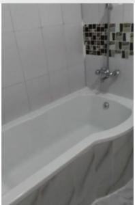 a white bath tub in a bathroom at Faigib Guest House in Chipata