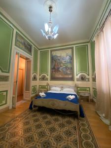 a bedroom with a bed and a painting on the wall at Hollywood Inn Palermo in Palermo
