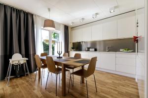a kitchen with a dining room table and chairs at Tallinn Residences in Petrikyula