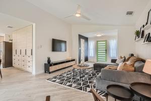 a living room with a couch and a tv at Cozy Stylish Home in Round Rock! in Round Rock