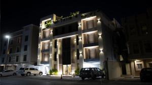 a building with cars parked in front of it at night at ناصرية العليا in Al Khobar