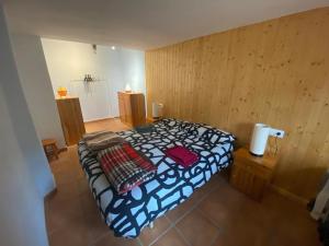 - une chambre avec un lit dans une pièce dotée de murs en bois dans l'établissement Cals Piris Casa Rural, à Cabacés