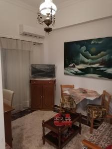 錫蒂亞的住宿－Nepheli，客厅配有桌子和墙上的绘画