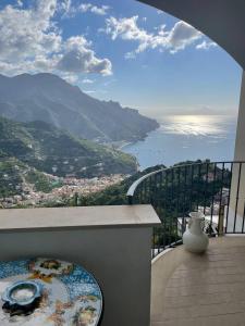 a balcony with a view of the ocean and mountains at La Dolce Vita Ravello in Ravello