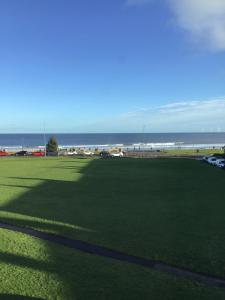 a large grass field with the ocean in the background at Sea View Guest House in Hartlepool