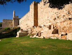a large stone wall with a castle in the background at Jaffa 17- shani studio suite in Jerusalem