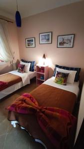 a hotel room with two beds and a couch at Chez Axia Tanger in Tangier