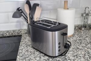 a toaster sitting on a kitchen counter next to a knife at Piso Puerta del Ángel in Jaén