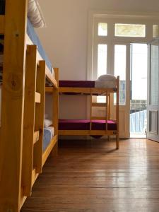 a room with two bunk beds and a staircase at MiBAQ Hostel in Buenos Aires