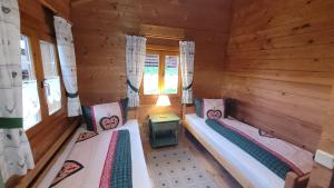 a room with two beds in a log cabin at Blockhaus mit WLAN Bayern in Stamsried