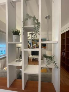 a white book shelf in a living room at DOMUS B Corso Francia apartment in Rome