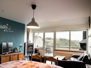 a living room with a table and a couch at Belle vue in Malmedy