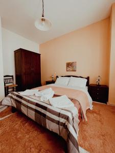a bedroom with a large bed with white pillows at Muses Apartments in Pisoderi