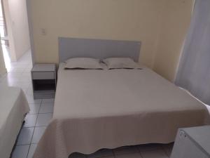 a bedroom with a large bed with two pillows at CASA DA SERRA na Chácara Paraíso in Bananeiras