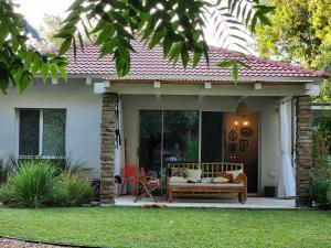 a house with a porch with a bench on it at שירת הגומא in Lahavot HaBashan