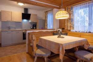 a kitchen and dining room with a table and chairs at Gästehaus Strauss in Seefeld in Tirol