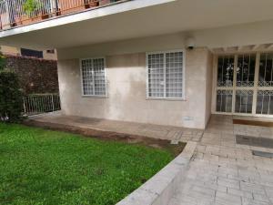 a house with a green lawn in front of it at DOMUS B Corso Francia apartment in Rome