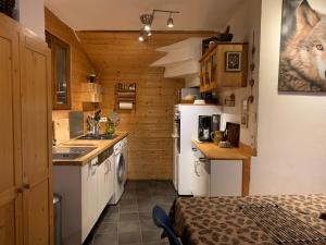 a small kitchen with a stove and a refrigerator at Chalet Martine in LʼHuez