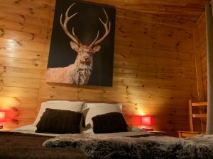 a bedroom with a painting of a deer on the wall at Chalet Martine in LʼHuez