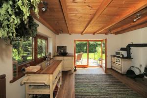 a kitchen with wooden ceilings and a wooden floor at Mazais Līvkalns in Sigulda