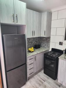 a kitchen with a stainless steel refrigerator and a stove at SiBella guest house in Bloemfontein