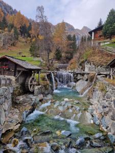 einen Fluss mit einer Brücke und einem Wasserfall in der Unterkunft Ferienhaus Reinhard Steiner in Hinterbichl