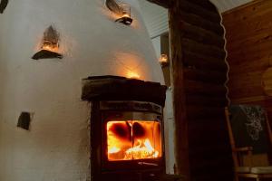 a brick oven with a fire inside of it at Kuukkeli Log Houses Aurora Cabin - Jaspis in Saariselka