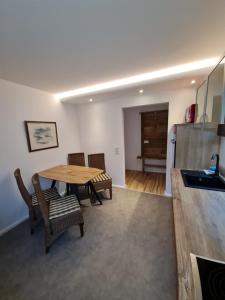 a kitchen and dining room with a table and chairs at Haus Fernblick in Kurort Bärenburg