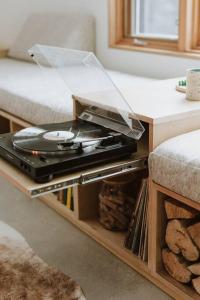 a record player on a table in a living room at Okt Häus in Nordegg