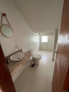 a bathroom with a sink and a toilet at Casa inteira em C Vermelha in Porto Seguro