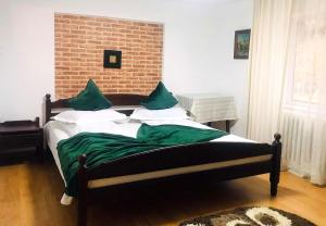 a bedroom with a bed with a brick wall at Apartament Sarco in Vatra Dornei