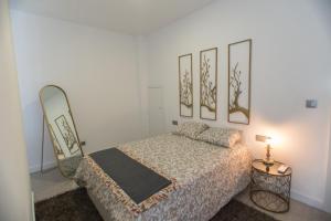 a bedroom with a bed and two pictures on the wall at Birds Apartments in Porto