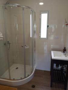 a bathroom with a shower and a sink at Cabañas La Fortaleza in La Caldera